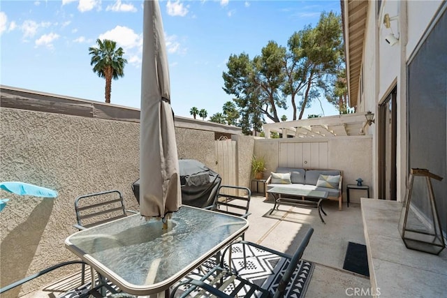 6134 Arroyo Rd Unit 3, Palm Springs, CA 92264 - fenced backyard with an outdoor living space, a patio area, outdoor dining area, and area for grilling
