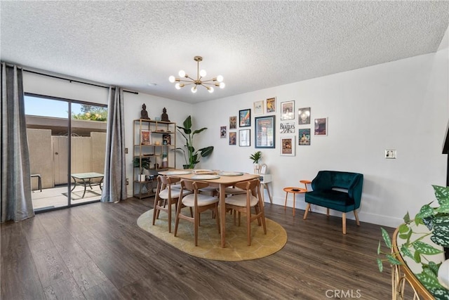 6134 Arroyo Rd Unit 3, Palm Springs, CA 92264 - dining room featuring a chandelier, wood finished floors, a textured ceiling, and baseboards