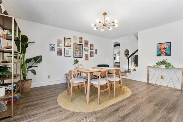 6134 Arroyo Rd Unit 3, Palm Springs, CA 92264 - dining room featuring a chandelier, wood finished floors, stairway, and baseboards