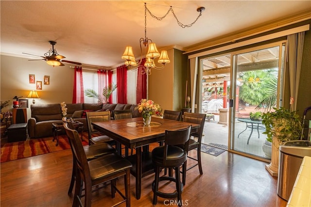 970 Riverview Cir, Corona, CA 92881 - dining space with crown molding, wood finished floors, a chandelier, and a ceiling fan