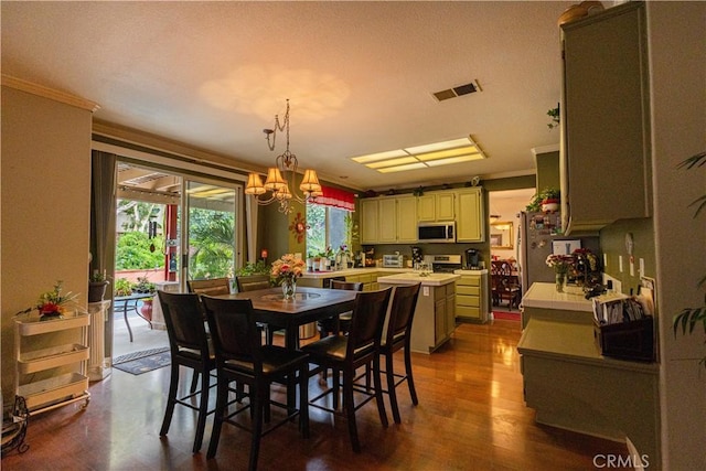 970 Riverview Cir, Corona, CA 92881 - dining room featuring crown molding, a chandelier, and dark wood finished floors