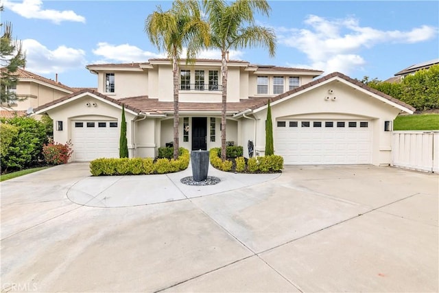 view of front of house featuring stucco siding, concrete driveway, an attached garage, a tiled roof, and solar panels