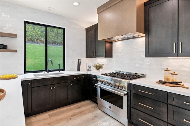 40225 Camino Campos Verde, Temecula, CA 92591 - kitchen with stainless steel stove, a sink, light countertops, custom exhaust hood, and light wood finished floors
