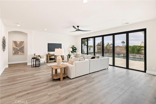 40225 Camino Campos Verde, Temecula, CA 92591 - living room featuring light wood-style flooring, recessed lighting, a ceiling fan, baseboards, and arched walkways
