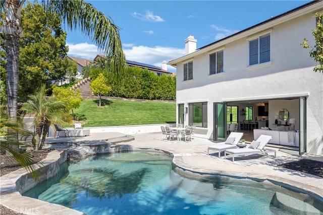 swimming pool featuring a patio area and a lawn