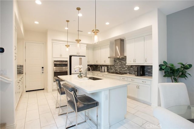 148 Spectacle, Irvine, CA 92618 - kitchen with freestanding refrigerator, wall chimney exhaust hood, stainless steel double oven, backsplash, and white cabinetry
