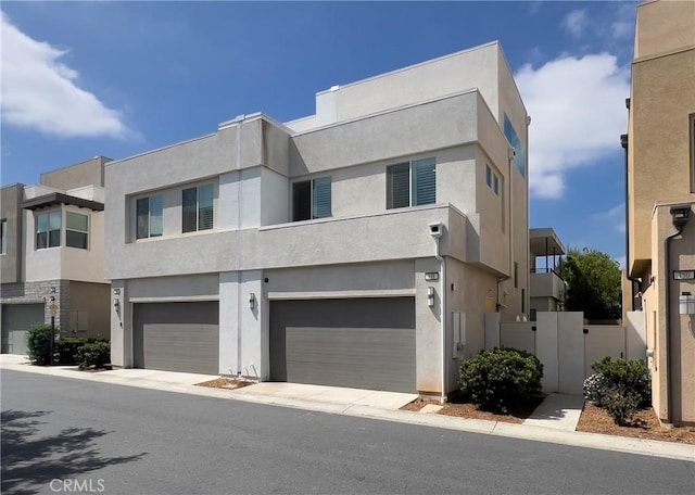 148 Spectacle, Irvine, CA 92618 - view of front of house featuring stucco siding and a garage