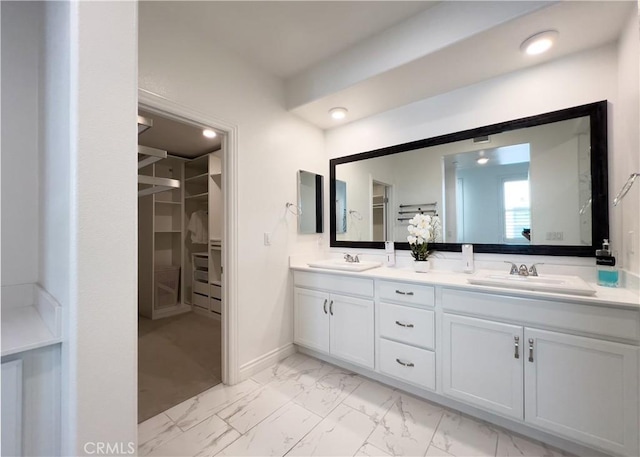 148 Spectacle, Irvine, CA 92618 - bathroom featuring marble look tile flooring, double vanity, and a walk in closet