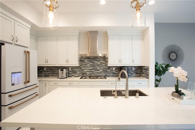 148 Spectacle, Irvine, CA 92618 - kitchen featuring white refrigerator with ice dispenser, wall chimney exhaust hood, tasteful backsplash, light countertops, and recessed lighting