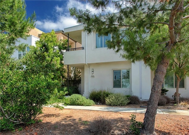 148 Spectacle, Irvine, CA 92618 - view of front of house with stucco siding and a balcony