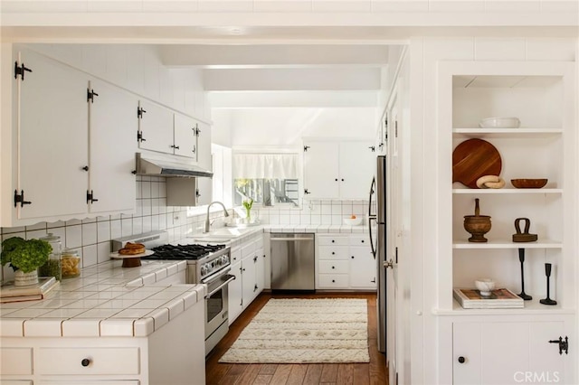 28956 Palisades Dr, Lake Arrowhead, CA 92352 - kitchen featuring stainless steel appliances, tile countertops, under cabinet range hood, a sink, and dark wood-type flooring