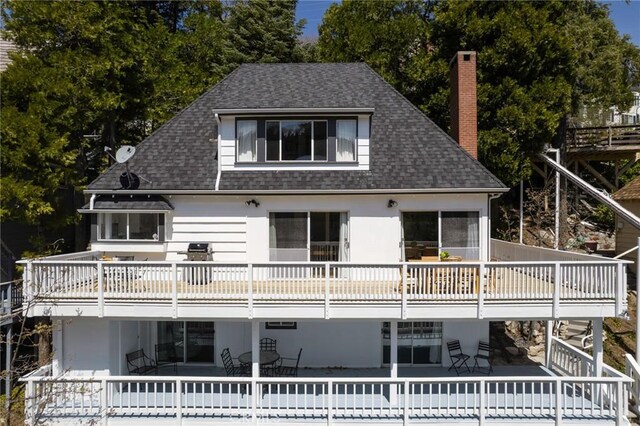 28956 Palisades Dr, Lake Arrowhead, CA 92352 - rear view of house featuring roof with shingles, a chimney, a patio, and a balcony