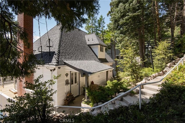 28956 Palisades Dr, Lake Arrowhead, CA 92352 - view of property exterior featuring a shingled roof, a chimney, and fence
