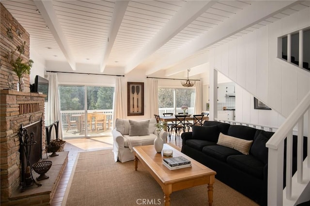 28956 Palisades Dr, Lake Arrowhead, CA 92352 - living area with beam ceiling, a fireplace with raised hearth, and wood finished floors