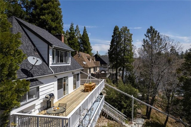 28956 Palisades Dr, Lake Arrowhead, CA 92352 - back of property with a shingled roof, a wooden deck, and stairs