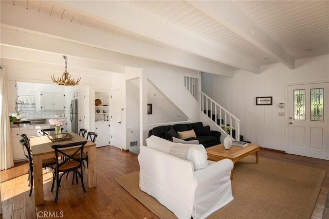 28956 Palisades Dr, Lake Arrowhead, CA 92352 - living room featuring stairway, wood-type flooring, beam ceiling, and a chandelier