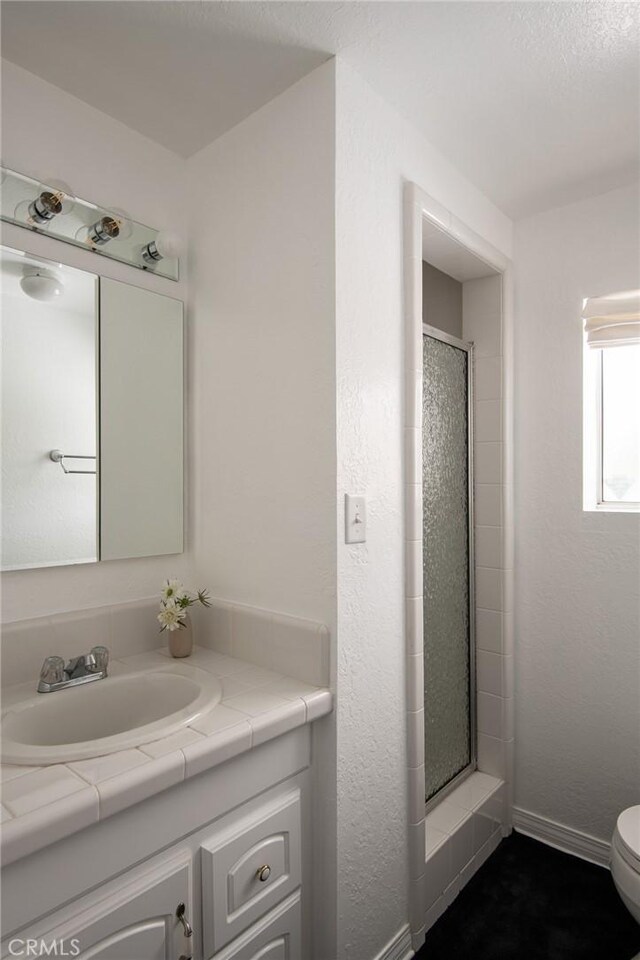 28956 Palisades Dr, Lake Arrowhead, CA 92352 - full bath with a stall shower, toilet, baseboards, and vanity
