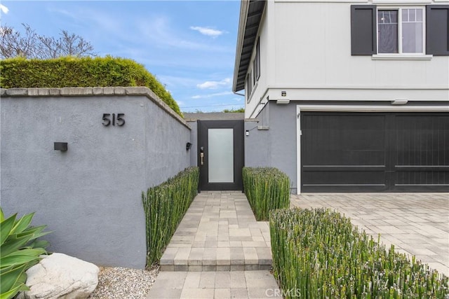 515 Traverse Dr, Costa Mesa, CA 92626 - property entrance with a garage and stucco siding