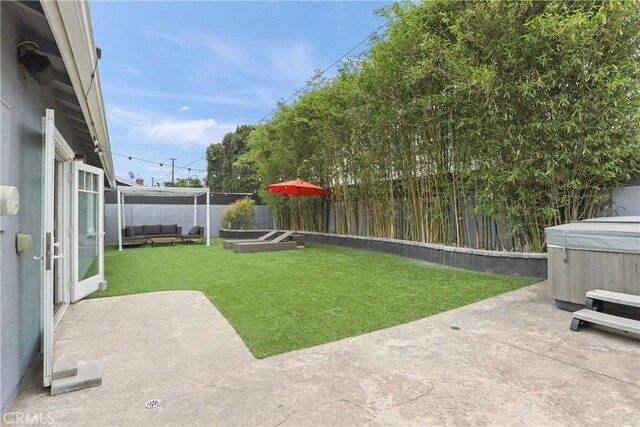 515 Traverse Dr, Costa Mesa, CA 92626 - view of yard with a hot tub, a patio, and an outdoor living space