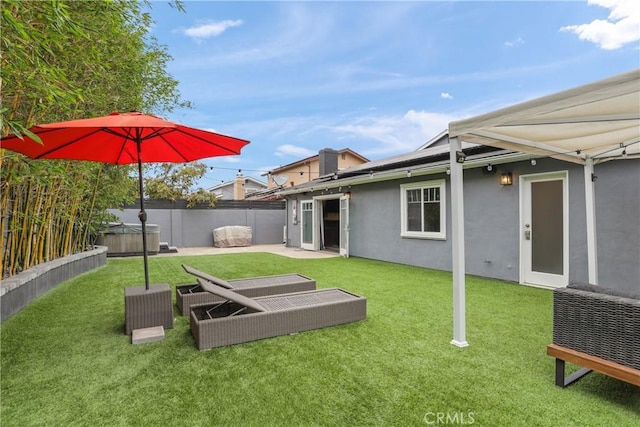 515 Traverse Dr, Costa Mesa, CA 92626 - back of property featuring stucco siding, a hot tub, and solar panels