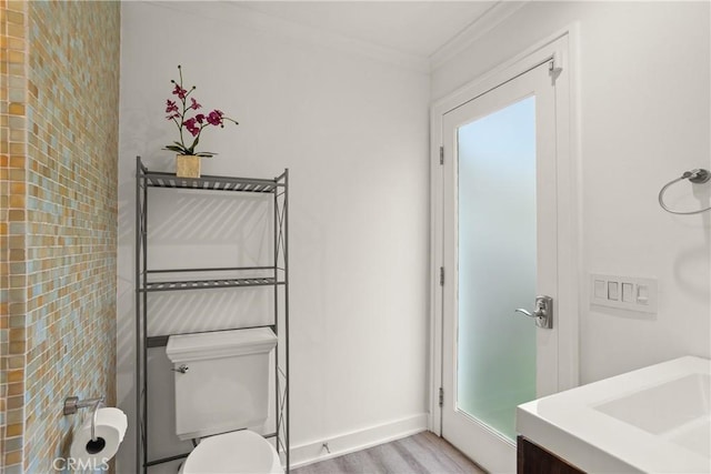 515 Traverse Dr, Costa Mesa, CA 92626 - bathroom featuring ornamental molding, toilet, a sink, wood finished floors, and baseboards