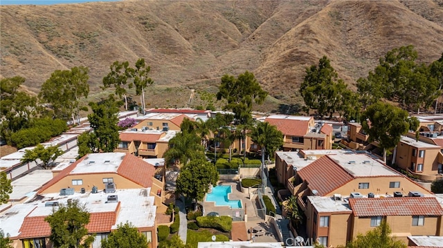 aerial view of residential area with mountains and a pool