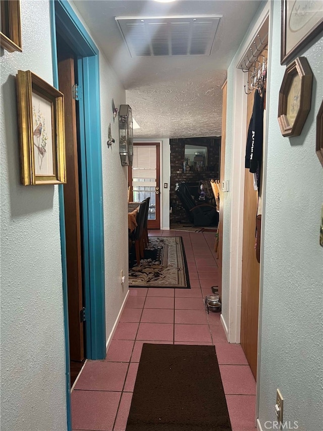 7477 Corona Ave, Hesperia, CA 92345 - hall featuring a textured wall, tile patterned flooring, baseboards, and a textured ceiling