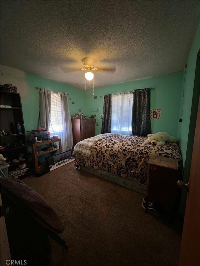 7477 Corona Ave, Hesperia, CA 92345 - carpeted bedroom featuring multiple windows, a textured ceiling, and ceiling fan