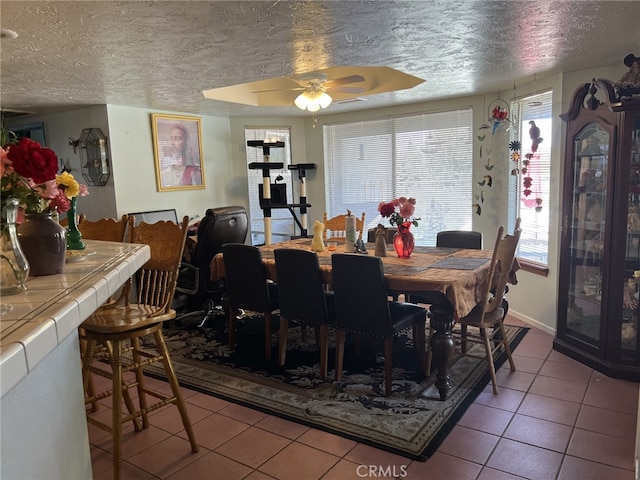 7477 Corona Ave, Hesperia, CA 92345 - tiled dining space with a ceiling fan and a textured ceiling