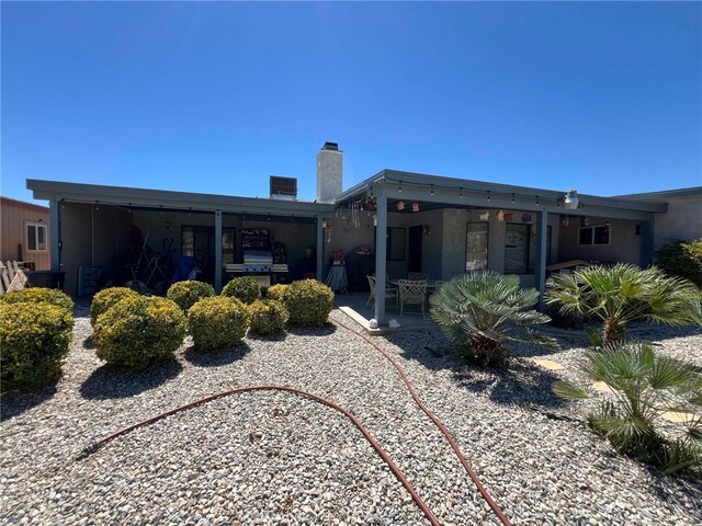 7477 Corona Ave, Hesperia, CA 92345 - back of property featuring a chimney and a patio