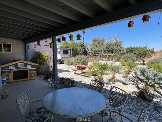 7477 Corona Ave, Hesperia, CA 92345 - view of patio with outdoor dining space and fence