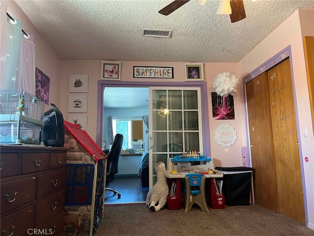 7477 Corona Ave, Hesperia, CA 92345 - game room featuring carpet, a ceiling fan, and a textured ceiling