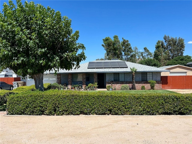 7477 Corona Ave, Hesperia, CA 92345 - view of front of house with solar panels, fence, and brick siding