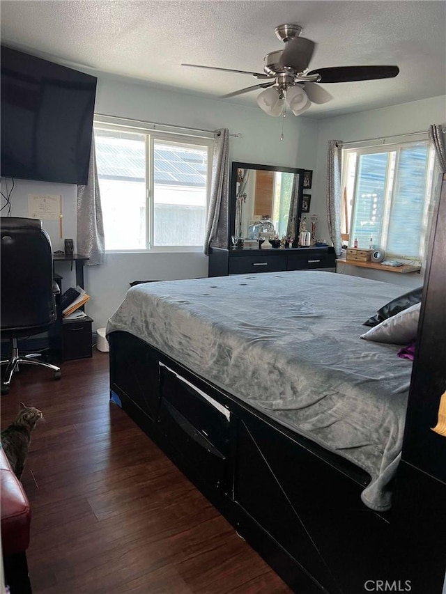 7477 Corona Ave, Hesperia, CA 92345 - bedroom with dark wood-type flooring, a textured ceiling, and ceiling fan