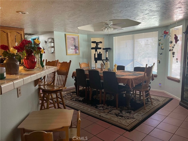 7477 Corona Ave, Hesperia, CA 92345 - dining room with a textured ceiling, ceiling fan, tile patterned floors, and baseboards