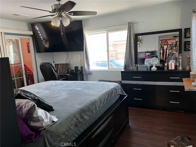 7477 Corona Ave, Hesperia, CA 92345 - bedroom with dark wood-type flooring, a closet, a ceiling fan, and a walk in closet