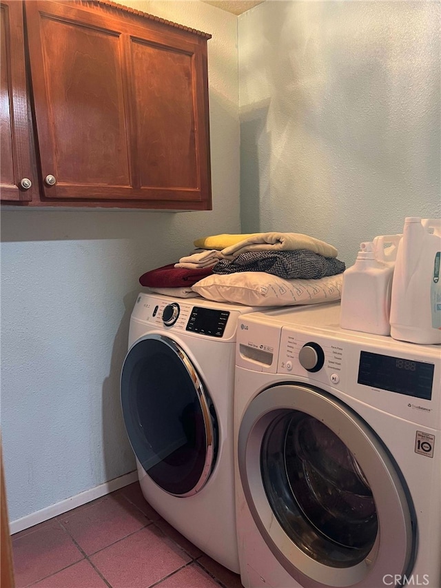 7477 Corona Ave, Hesperia, CA 92345 - washroom with separate washer and dryer, cabinet space, light tile patterned flooring, and baseboards