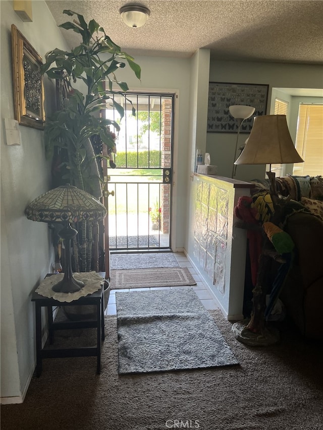 7477 Corona Ave, Hesperia, CA 92345 - entryway featuring a textured ceiling, baseboards, and carpet