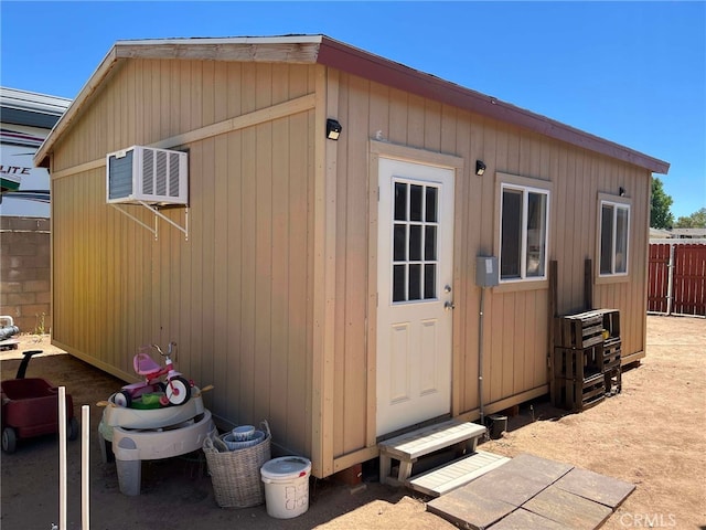 7477 Corona Ave, Hesperia, CA 92345 - view of outdoor structure featuring fence, an outbuilding, and an AC wall unit