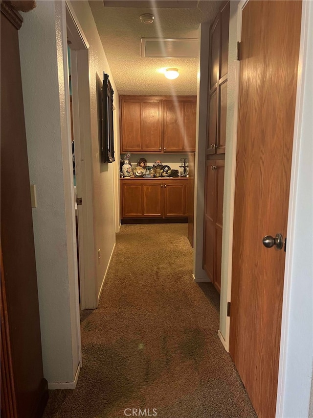 7477 Corona Ave, Hesperia, CA 92345 - hallway featuring carpet flooring, a textured ceiling, and baseboards