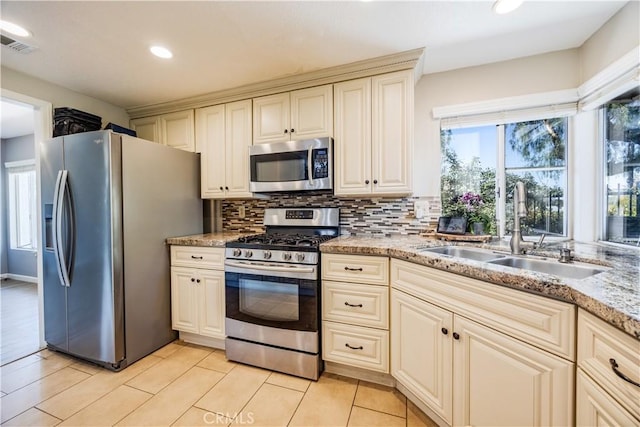 30681 Southern Cross Rd, Temecula, CA 92592 - kitchen featuring appliances with stainless steel finishes, a sink, cream cabinets, tasteful backsplash, and recessed lighting