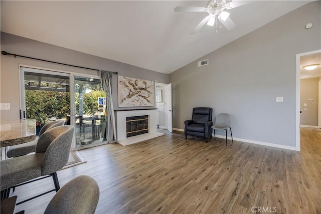 30681 Southern Cross Rd, Temecula, CA 92592 - living area with vaulted ceiling, wood finished floors, ceiling fan, a fireplace, and baseboards