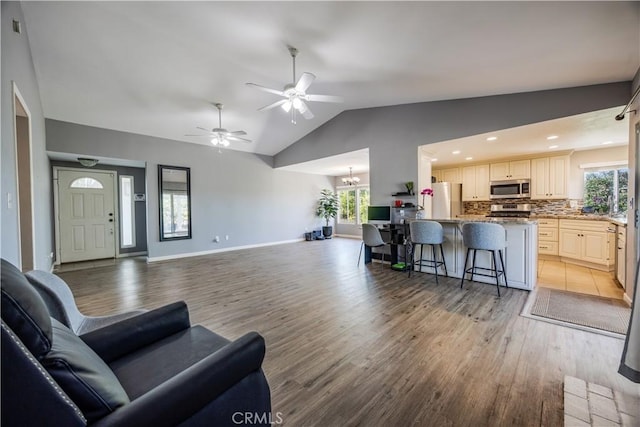 30681 Southern Cross Rd, Temecula, CA 92592 - living area featuring light wood-type flooring, vaulted ceiling, a ceiling fan, a chandelier, and recessed lighting