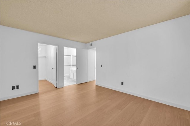 22800 Hilton Head Dr Unit 305, Diamond Bar, CA 91765 - unfurnished room with light wood finished floors, baseboards, and a textured ceiling