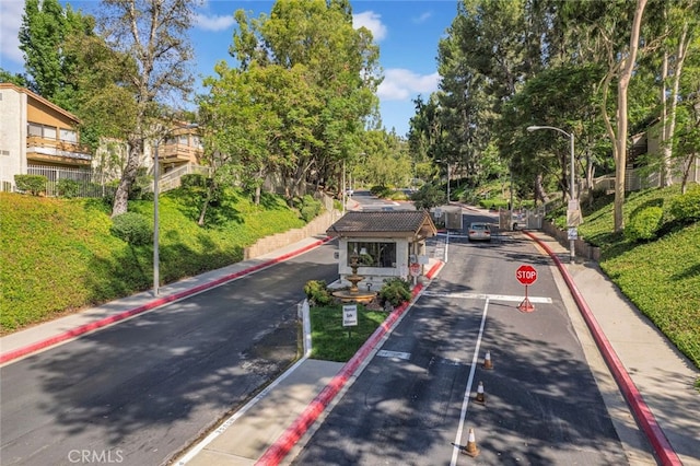 22800 Hilton Head Dr Unit 305, Diamond Bar, CA 91765 - view of asphalt road featuring curbs, traffic signs, street lighting, and sidewalks