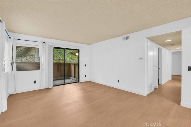 22800 Hilton Head Dr Unit 305, Diamond Bar, CA 91765 - unfurnished room with light wood finished floors, a textured ceiling, and baseboards