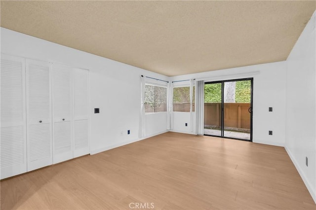 22800 Hilton Head Dr Unit 305, Diamond Bar, CA 91765 - unfurnished bedroom featuring access to exterior, wood finished floors, and baseboards