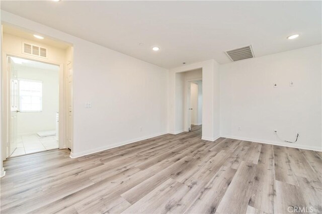 5961 Silveira St, Eastvale, CA 92880 - empty room with light wood-style floors, recessed lighting, and baseboards
