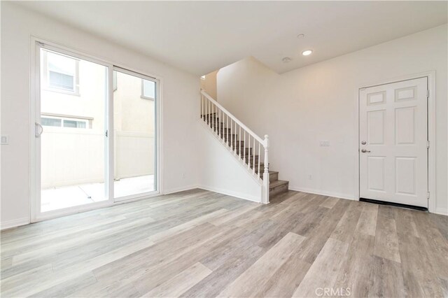 5961 Silveira St, Eastvale, CA 92880 - entrance foyer featuring stairs, light wood-style flooring, baseboards, and recessed lighting