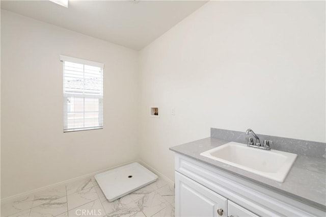 5961 Silveira St, Eastvale, CA 92880 - laundry room featuring washer hookup, light marble finish floors, baseboards, and cabinet space